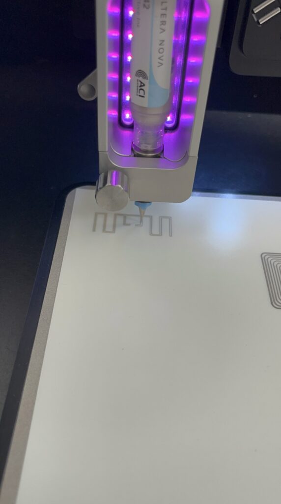 Printer printing an antenna with conductive ink on a flexible substrate.